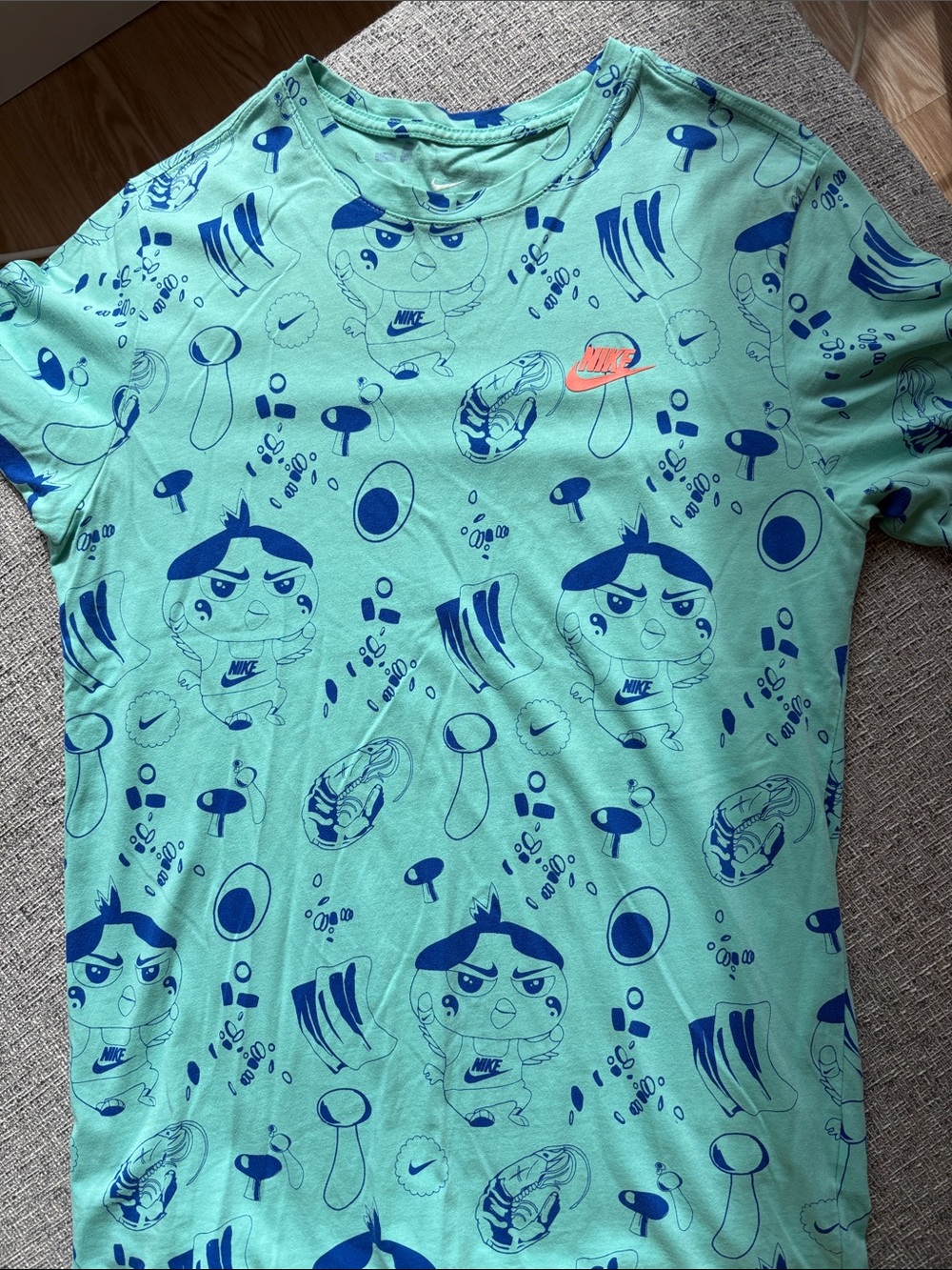 Nike Men’s Mint Green Shirt with Blue Graphics and Orange Logo